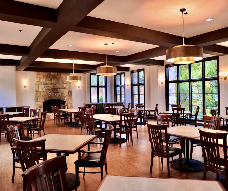 Dining area with tables and chairs strewn throughout